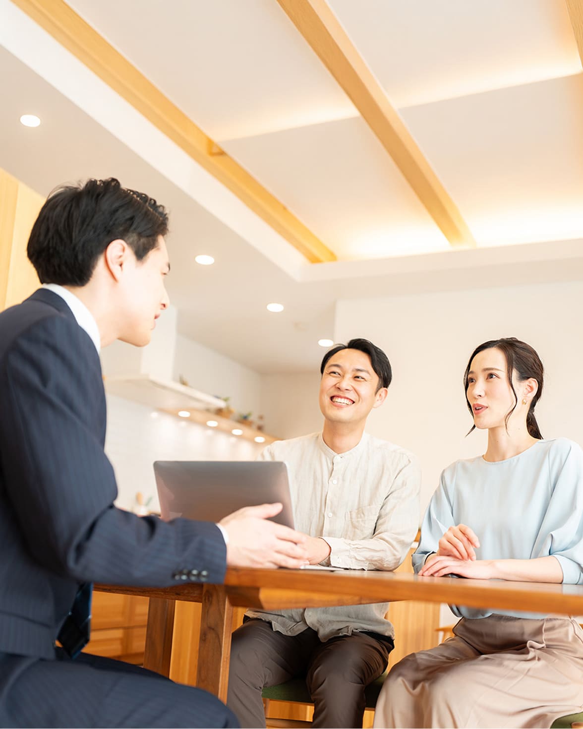 テーブルで打ち合わせをする夫婦と担当者